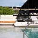 a pool with chairs and a chair in the middle