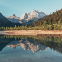 a lake with a dock and mountains in the background