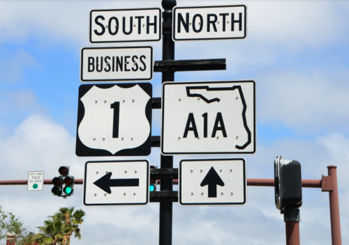 a street sign with a green light