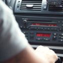 a person's hand on a car dashboard