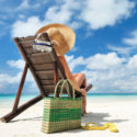 a woman sitting on a chair on a beach