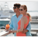 a man and woman standing on a railing