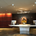 a man and woman standing at a reception desk