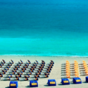 a beach with chairs and umbrellas