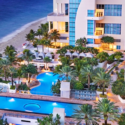 a hotel with a pool and palm trees