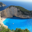 a boat on a beach surrounded by water