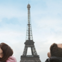 a group of people looking at the eiffel tower