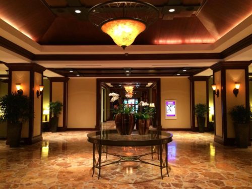 a large room with a table and plants