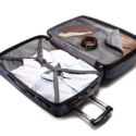 a suitcase with clothes and belt