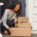 a woman holding a stack of boxes