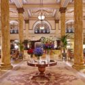 a large room with columns and flowers