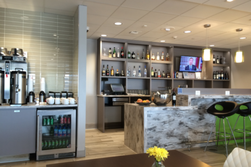 a bar with shelves of liquor and a television