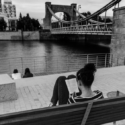 a woman sitting on a bench reading a book