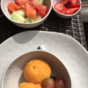 a bowl of fruit and ice cream