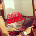 a woman sitting at a table with a tablet