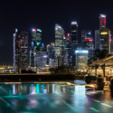 a pool with a city skyline at night