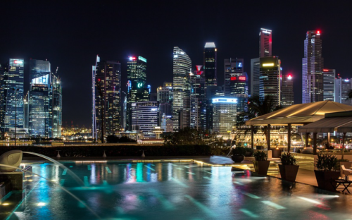 a pool with a city skyline at night