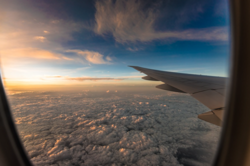 an airplane wing above the clouds