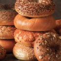 a stack of bagels with seeds on top