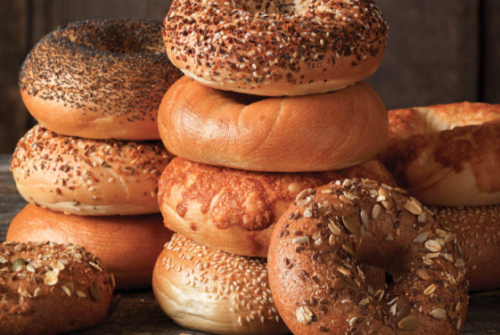 a stack of bagels with seeds on top
