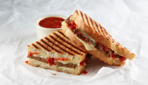 a grilled sandwich with sauce