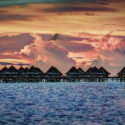 a group of houses on stilts in the water