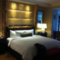 a bed with a headboard in a hotel room