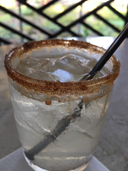 a glass with ice and a spoon in it