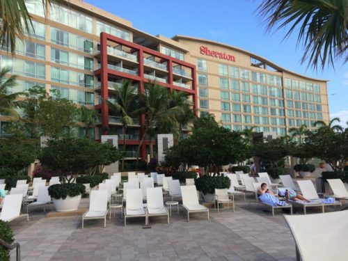 a group of people sitting in chairs outside of a hotel