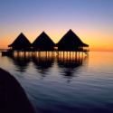 a group of huts on stilts on water