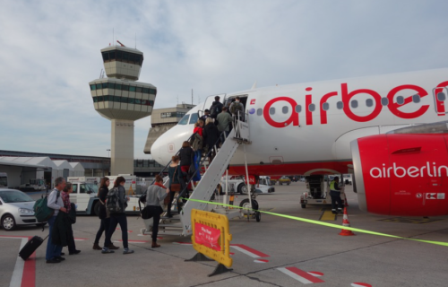 people boarding a plane at an airport