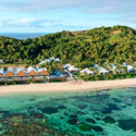 a beach with buildings and a body of water