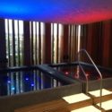 a pool with lights in a room