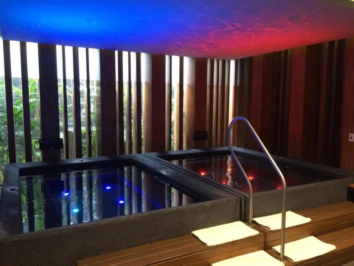 a hot tub with lights in a room