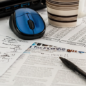 a computer mouse and a mug on a table