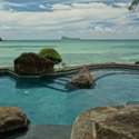 a pool with rocks and a body of water