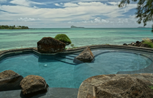 a pool with rocks and a body of water