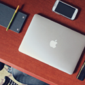 a laptop and cell phone on a desk