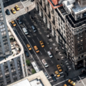 a city street with many cars and people