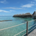 a dock with huts on the water