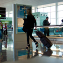 a woman walking with luggage in an airport