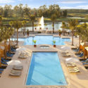 a pool with chairs and a fountain