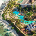 an aerial view of a resort with a pool and a beach