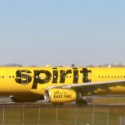 a yellow airplane with black writing on it