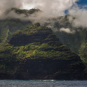 a mountain with clouds above it