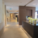 a long hallway with white vases on a counter