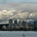 a city in the distance with mountains in the background