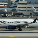 a group of airplanes on a runway