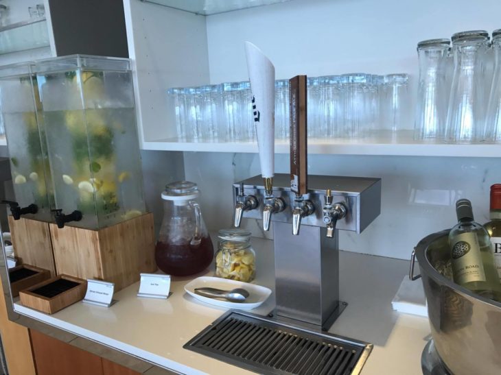 a counter with a drink dispenser and a drink dispenser