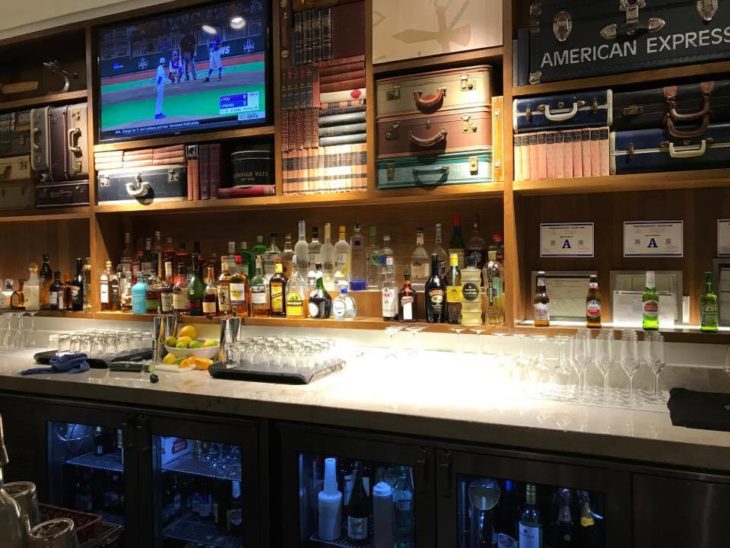 a bar with shelves of liquor and a television